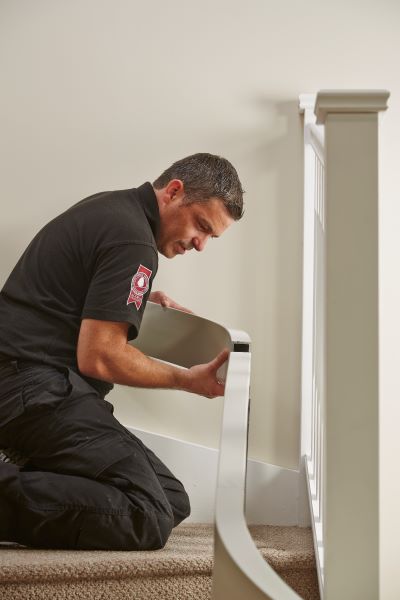 Acorn installer installing a stairlift into a client's household
